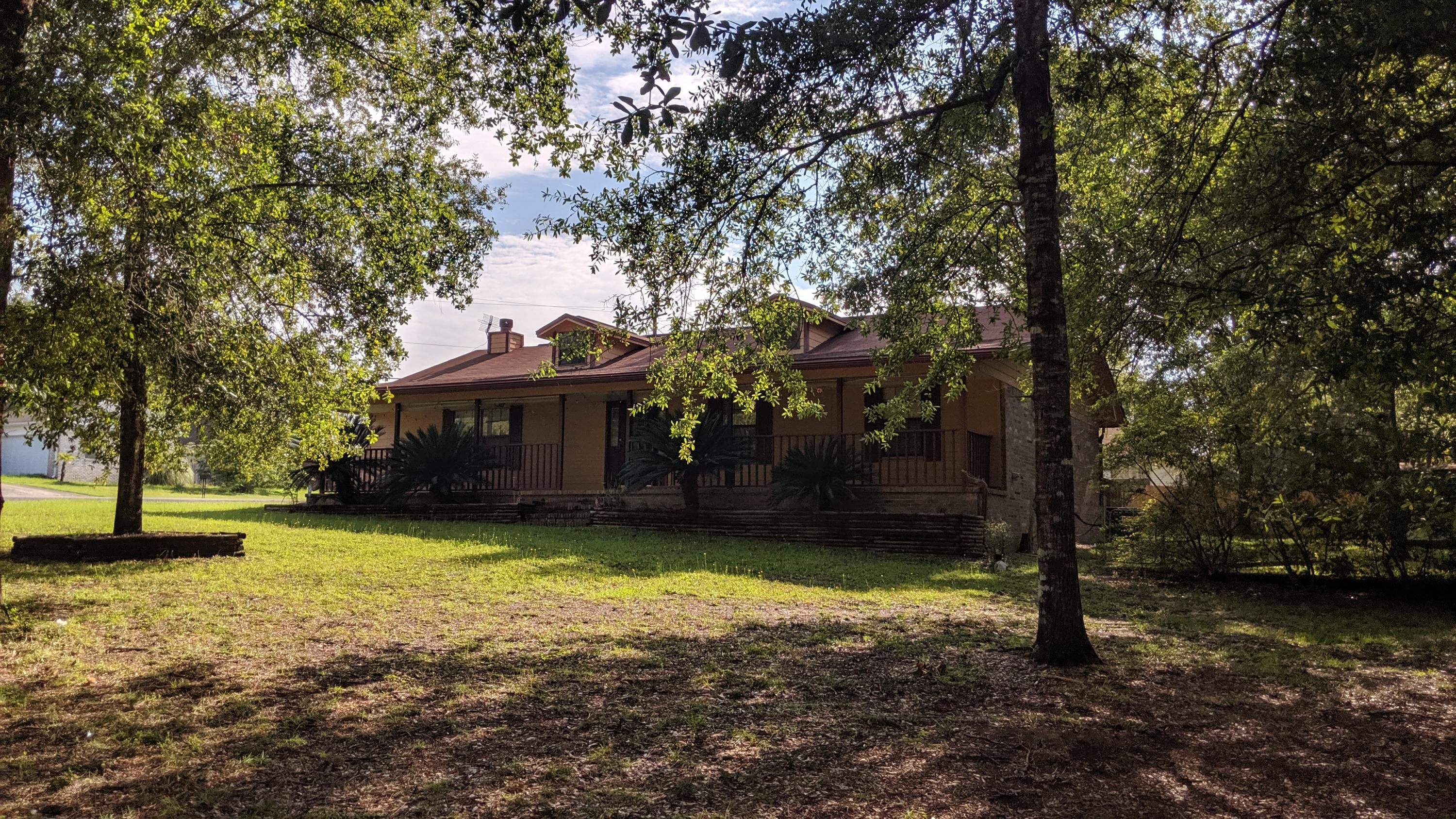 602 Valley Road Crestview, FL 32539 - Photo 2 of 34 a view of a house with swimming pool next to a yard