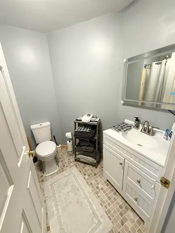 a bathroom with a sink toilet and mirror