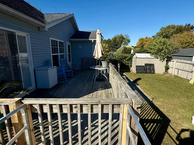 a view of a house with backyard and deck
