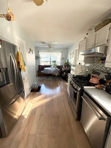 a kitchen with sink refrigerator and stove