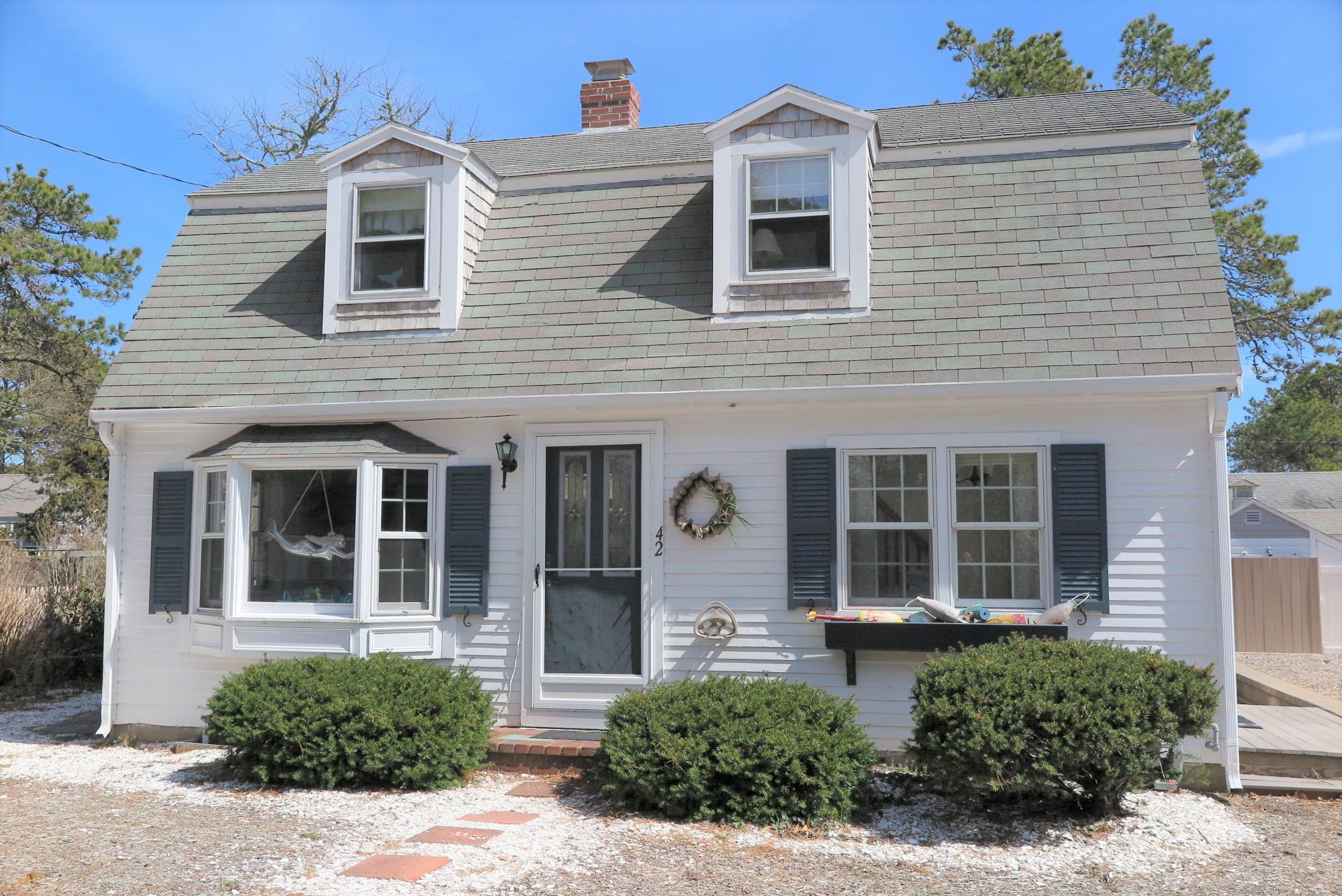 42 Bain Road Dennis Port, MA 02639 - Photo 1 of 46 a front view of a house with a yard