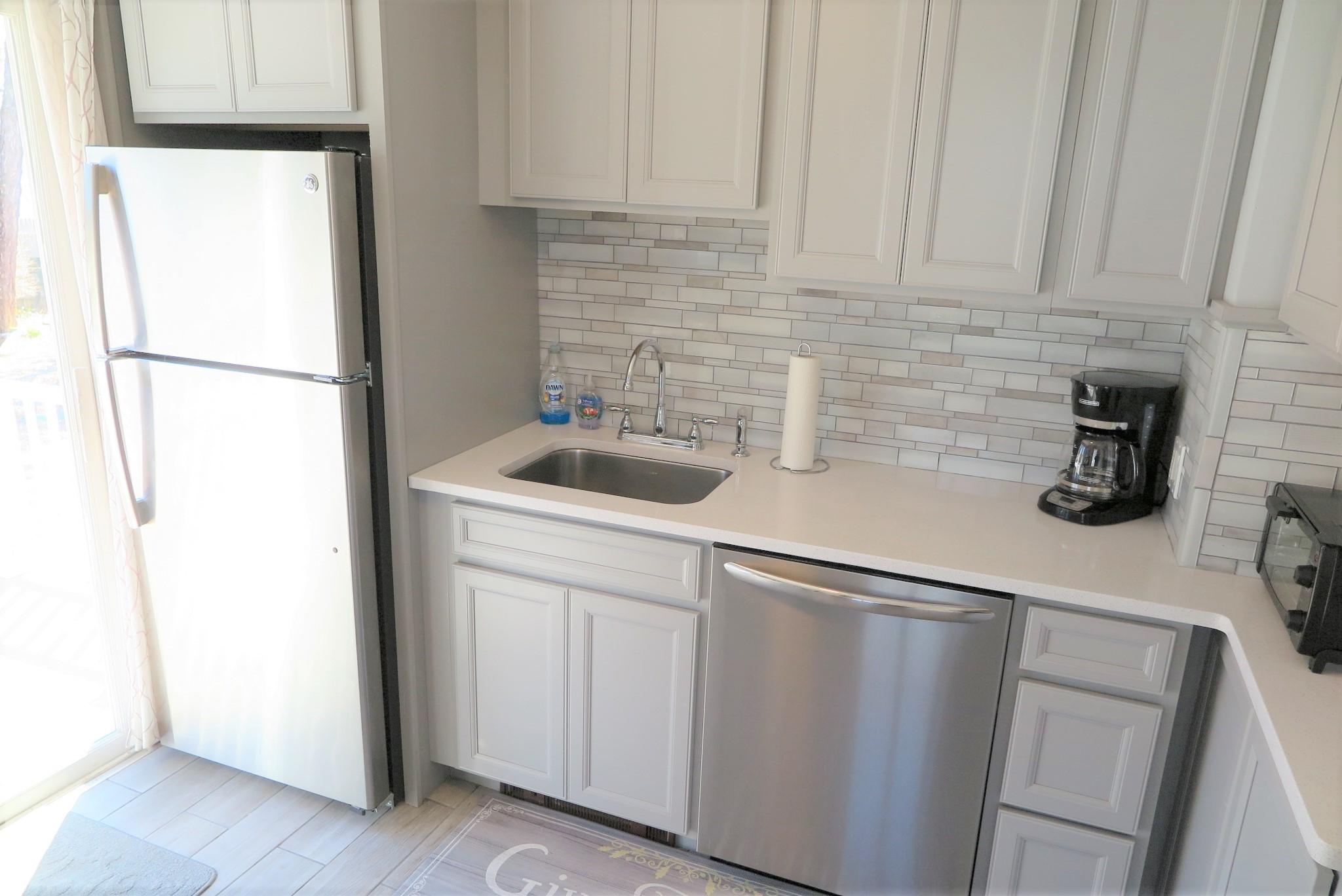 42 Bain Road Dennis Port, MA 02639 - Photo 13 of 46 a kitchen with a sink and refrigerator