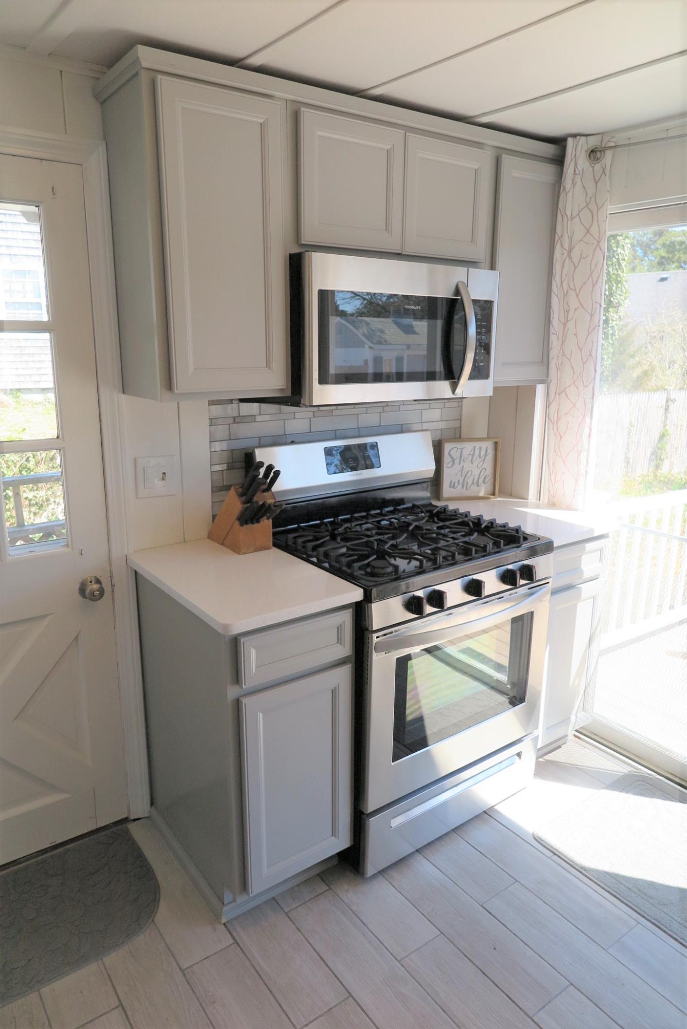 42 Bain Road Dennis Port, MA 02639 - Photo 14 of 46 a kitchen with a stove and a microwave