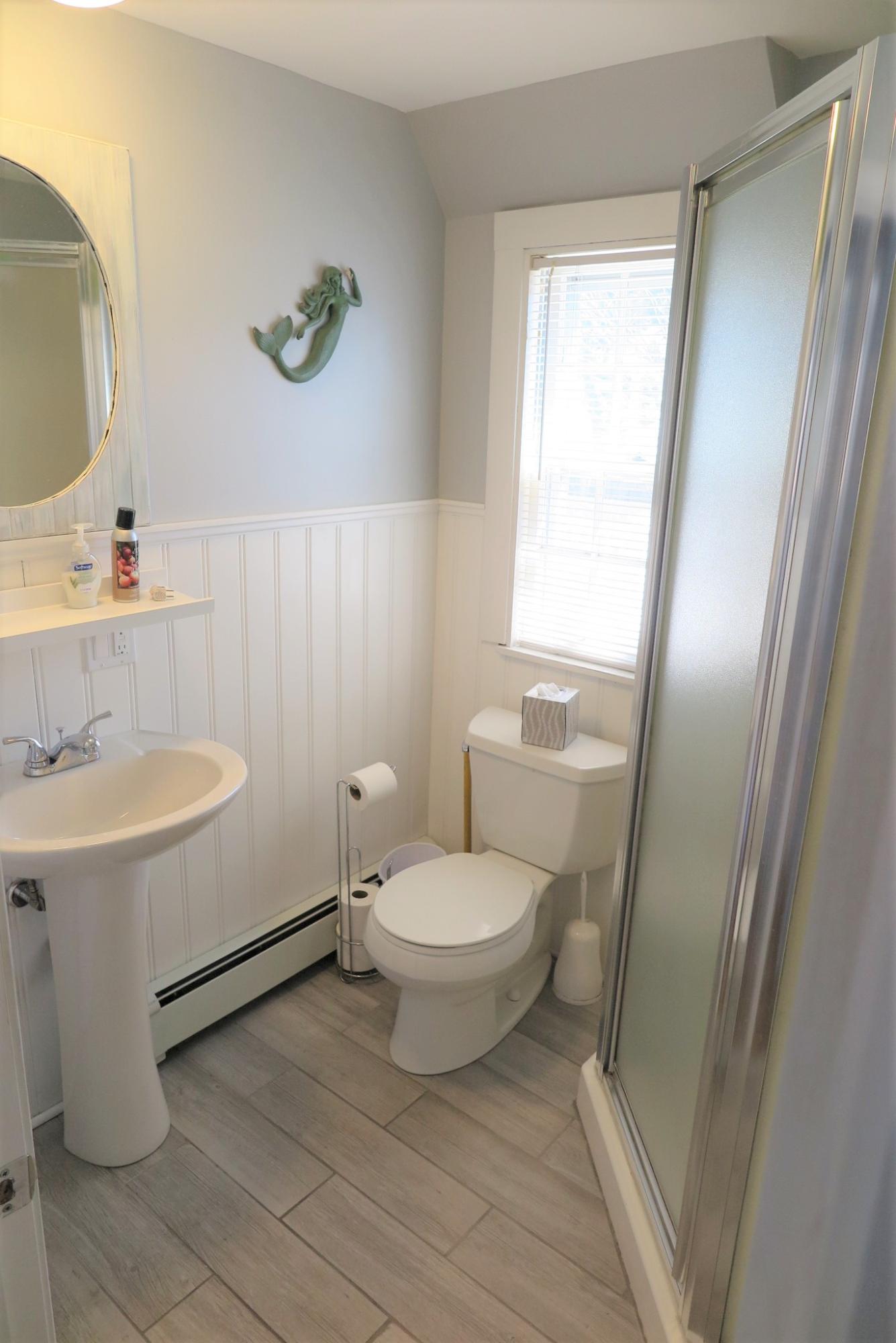 42 Bain Road Dennis Port, MA 02639 - Photo 16 of 46 a bathroom with a sink a toilet and shower