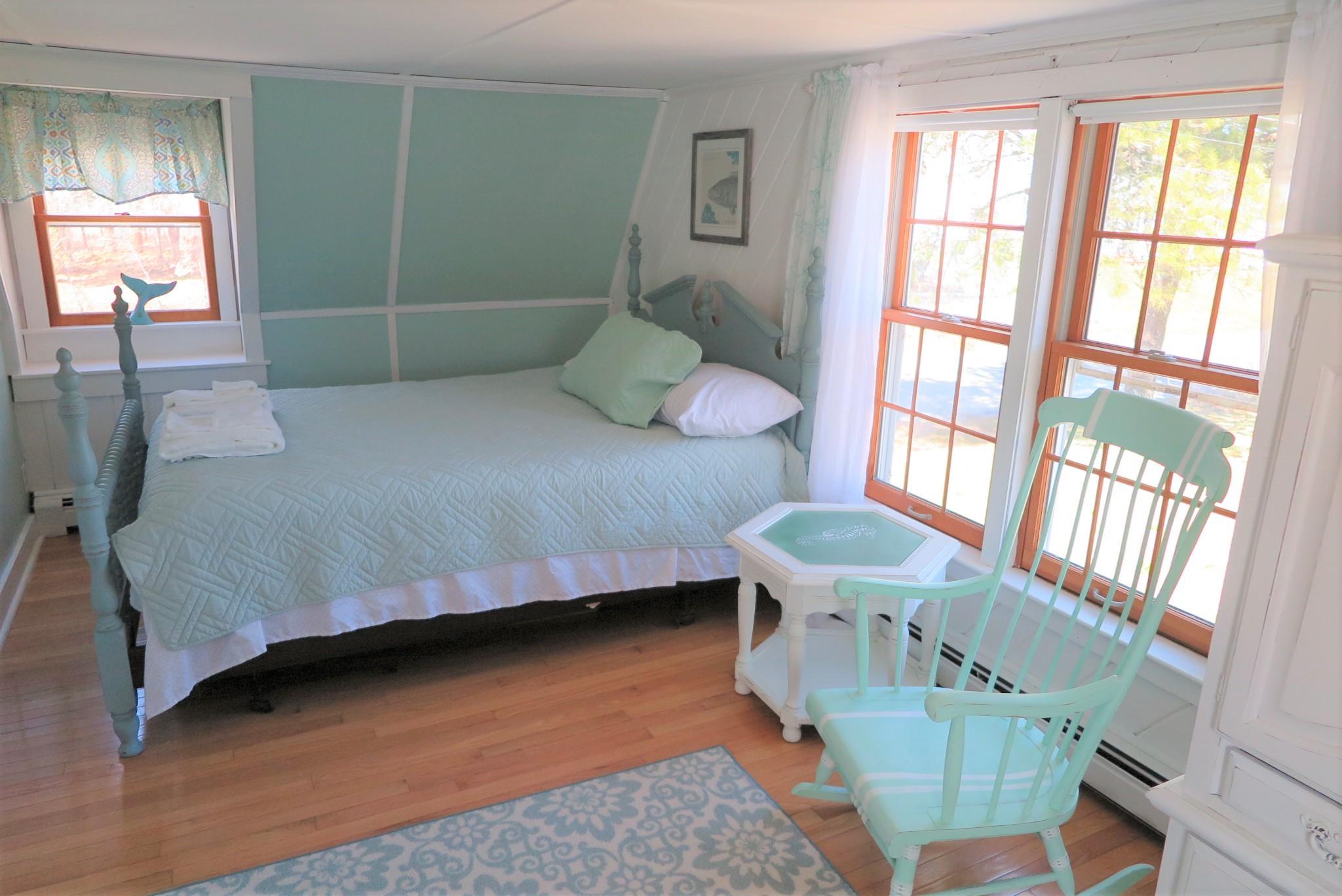 42 Bain Road Dennis Port, MA 02639 - Photo 22 of 46 a bedroom with a bed and windows