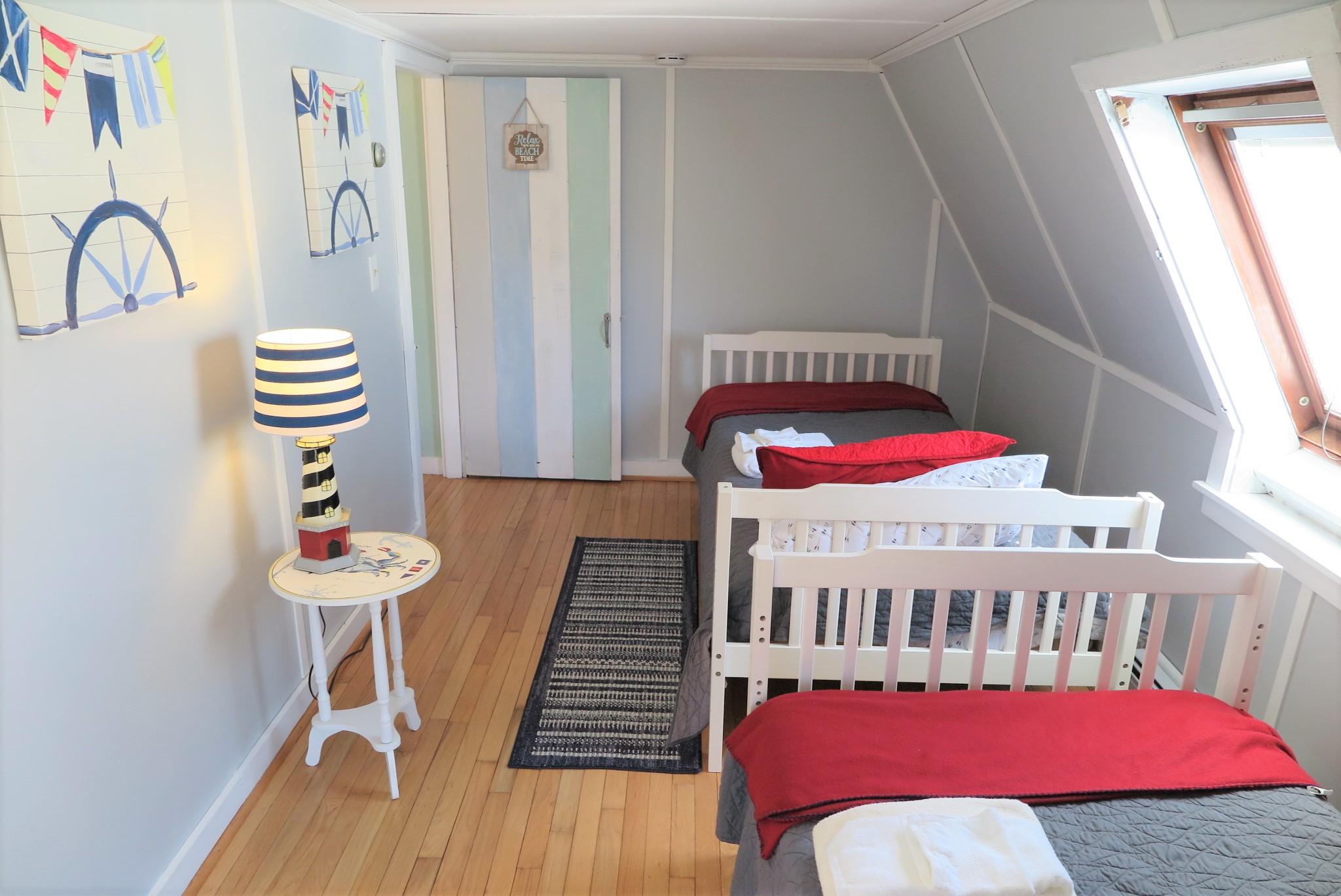 42 Bain Road Dennis Port, MA 02639 - Photo 30 of 46 a view of a bedroom with furniture and wooden floor