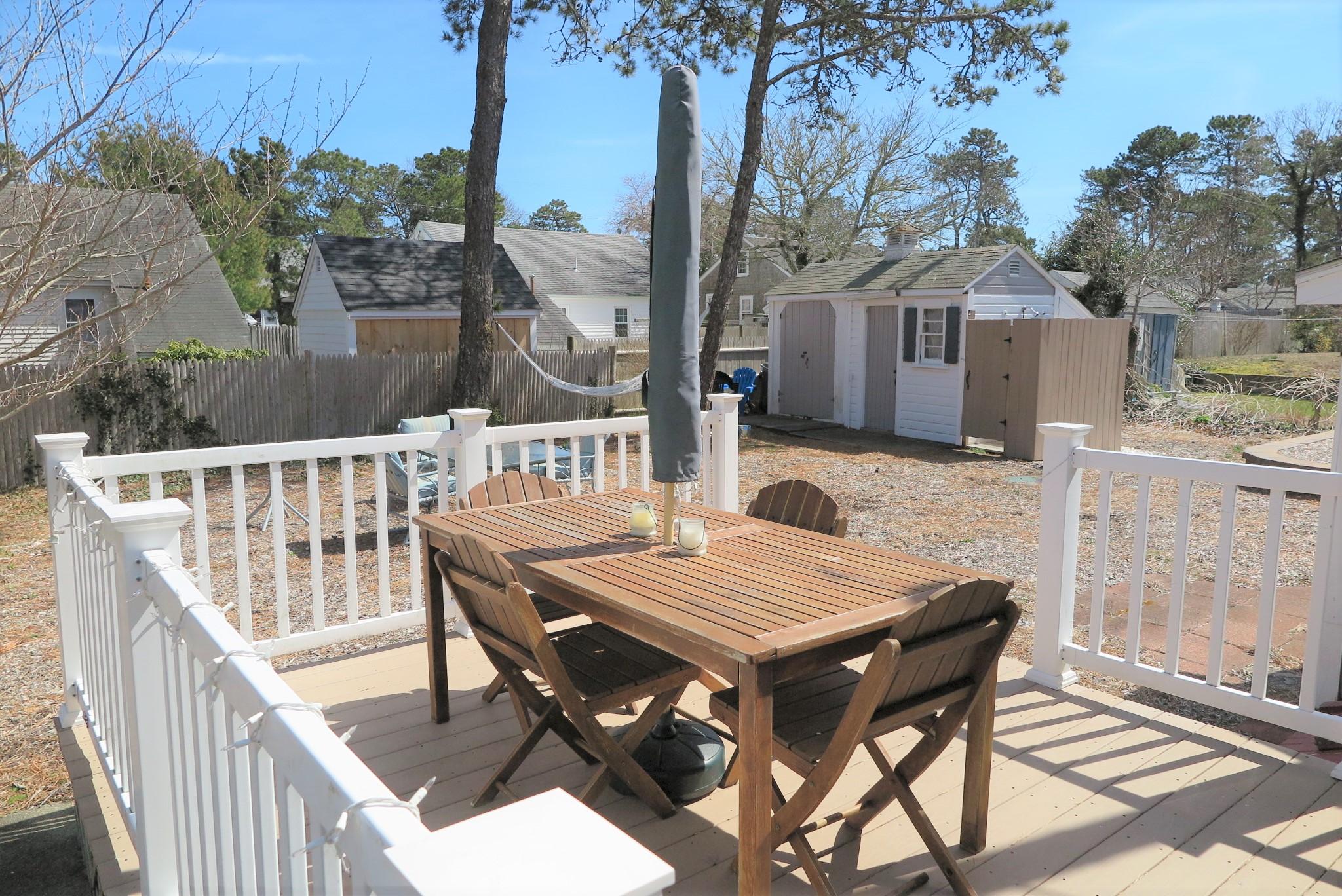 42 Bain Road Dennis Port, MA 02639 - Photo 3 of 46 a terrace with outdoor seating and wooden floor