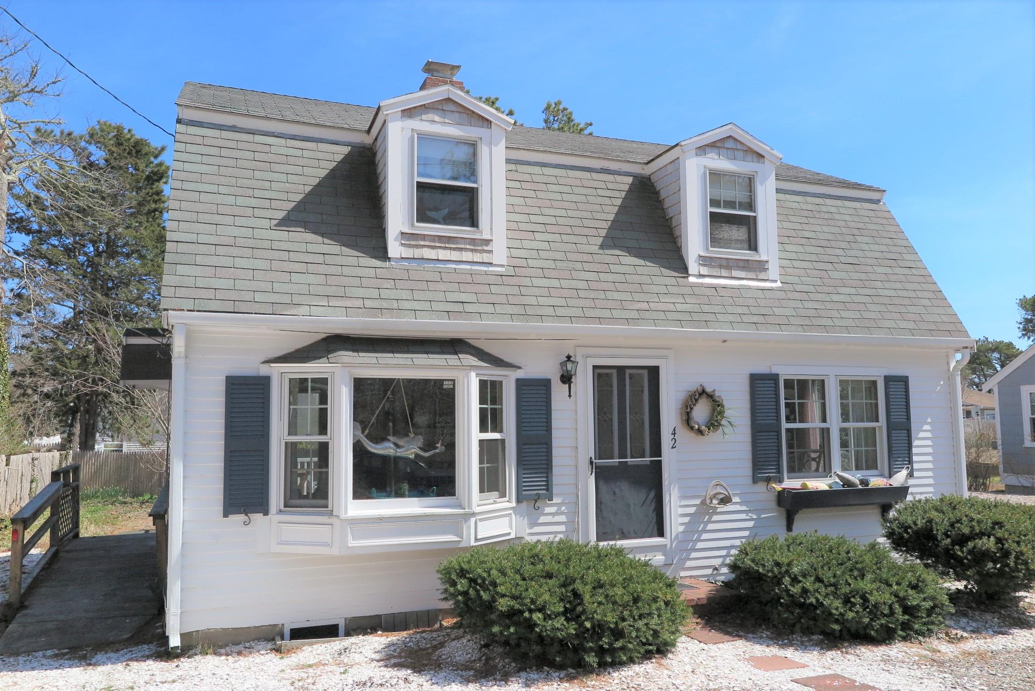 42 Bain Road Dennis Port, MA 02639 - Photo 34 of 46 a front view of a house with a yard