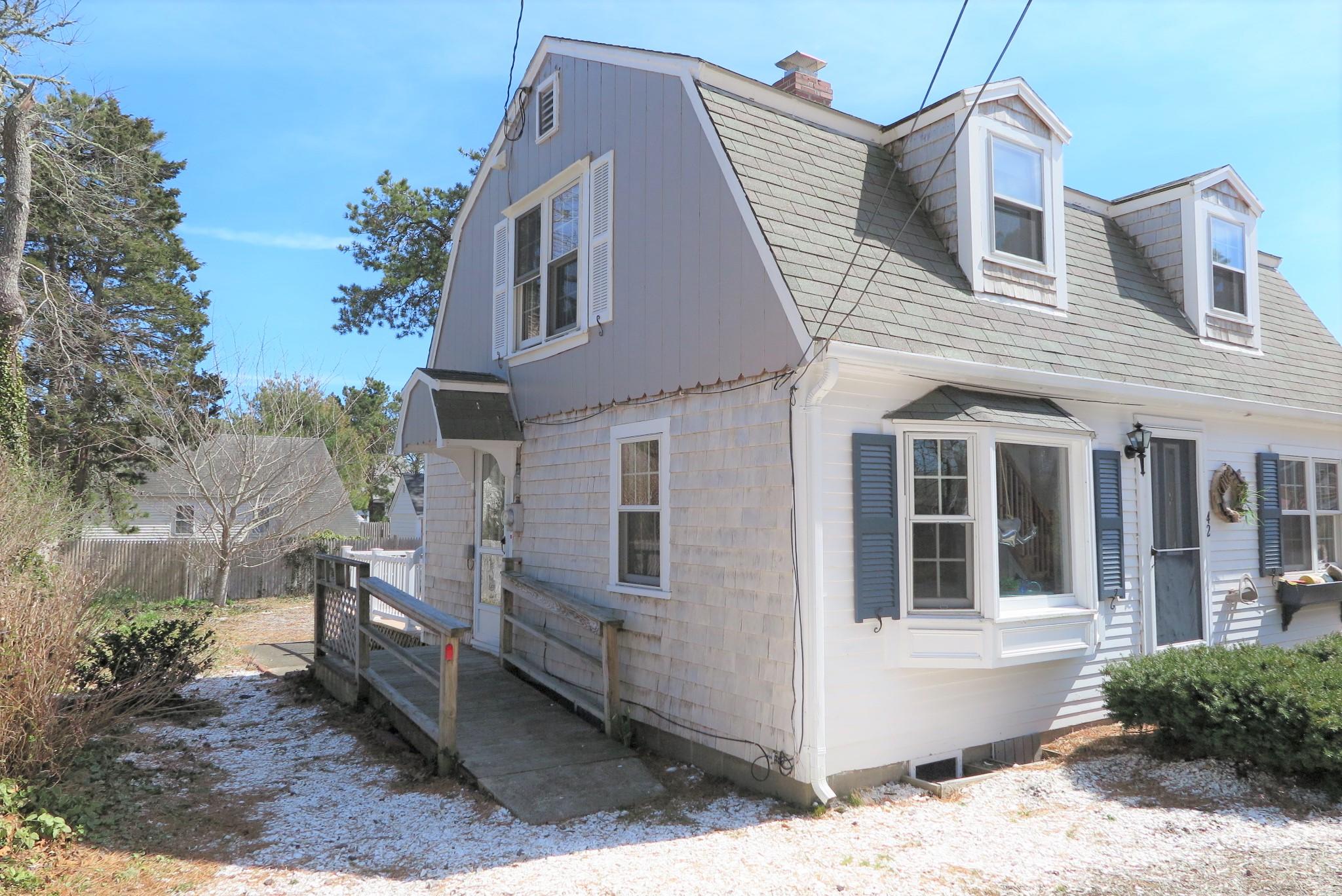42 Bain Road Dennis Port, MA 02639 - Photo 36 of 46 a front view of a house with a yard