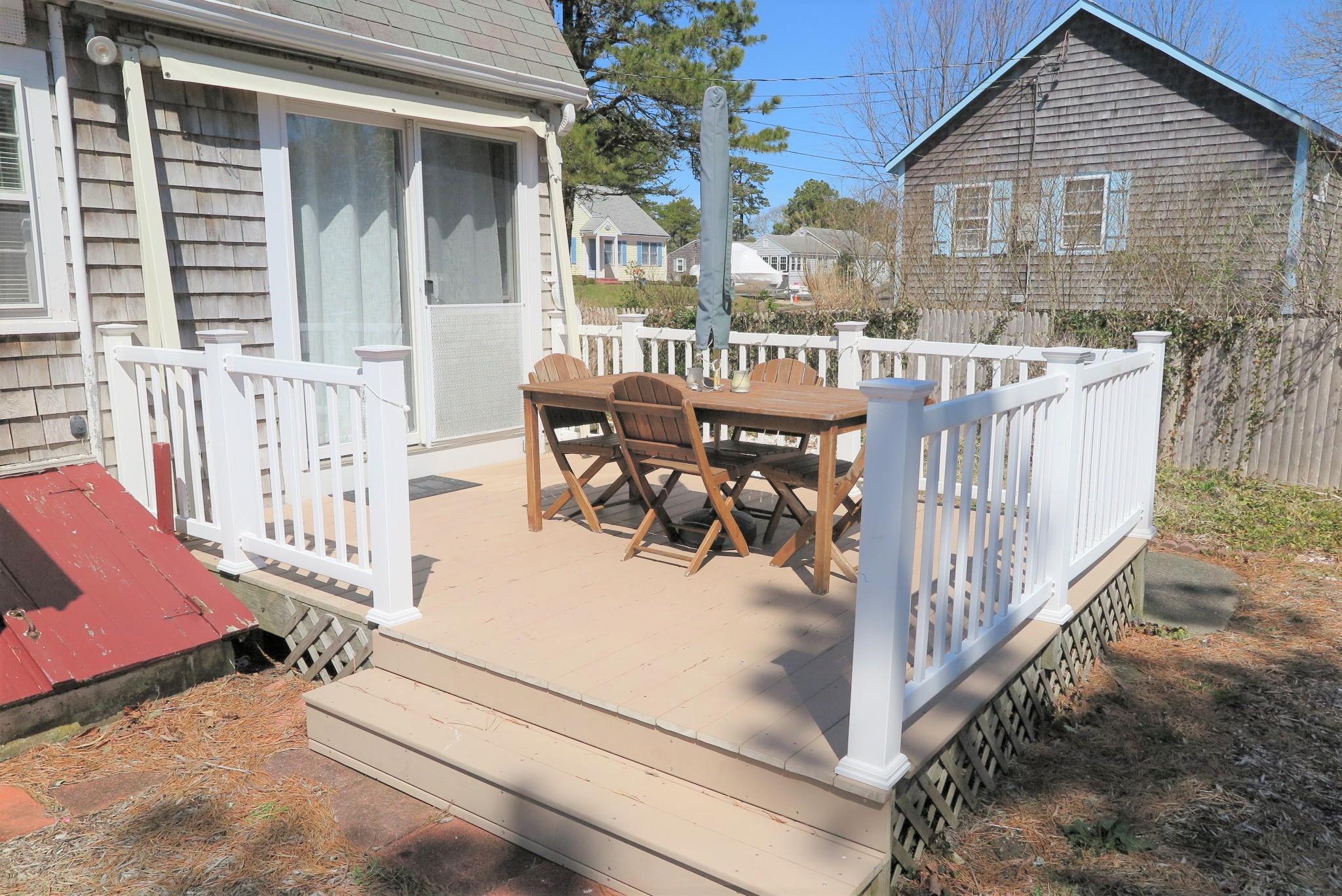 42 Bain Road Dennis Port, MA 02639 - Photo 4 of 46 a view of a house with wooden fence