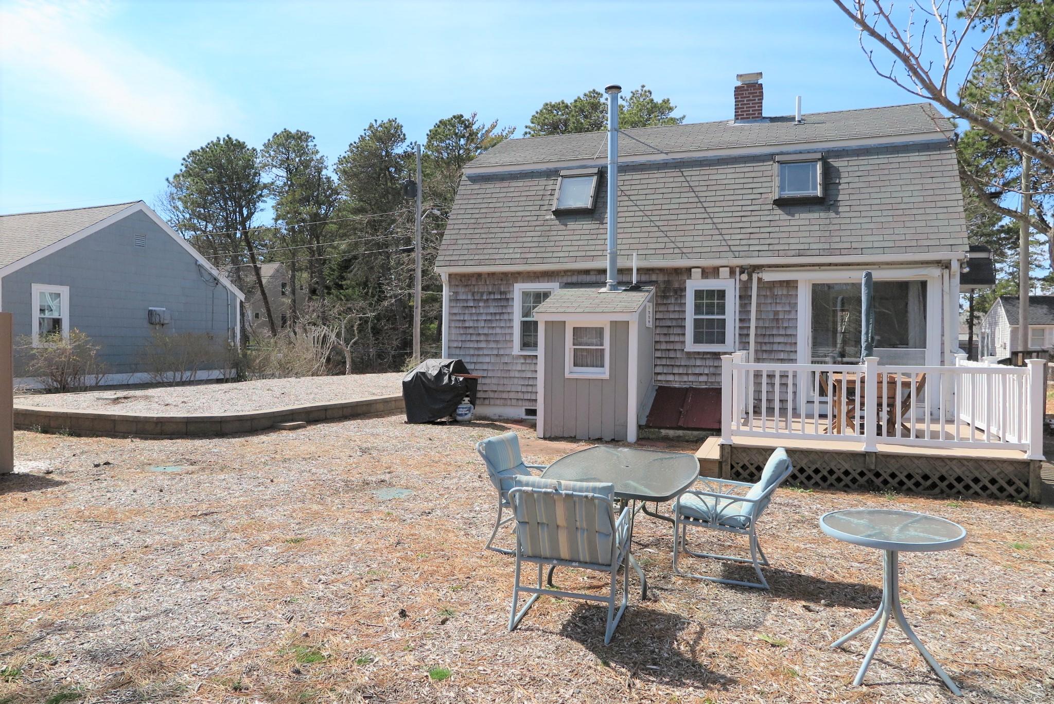 42 Bain Road Dennis Port, MA 02639 - Photo 41 of 46 a view of a house with backyard and sitting area