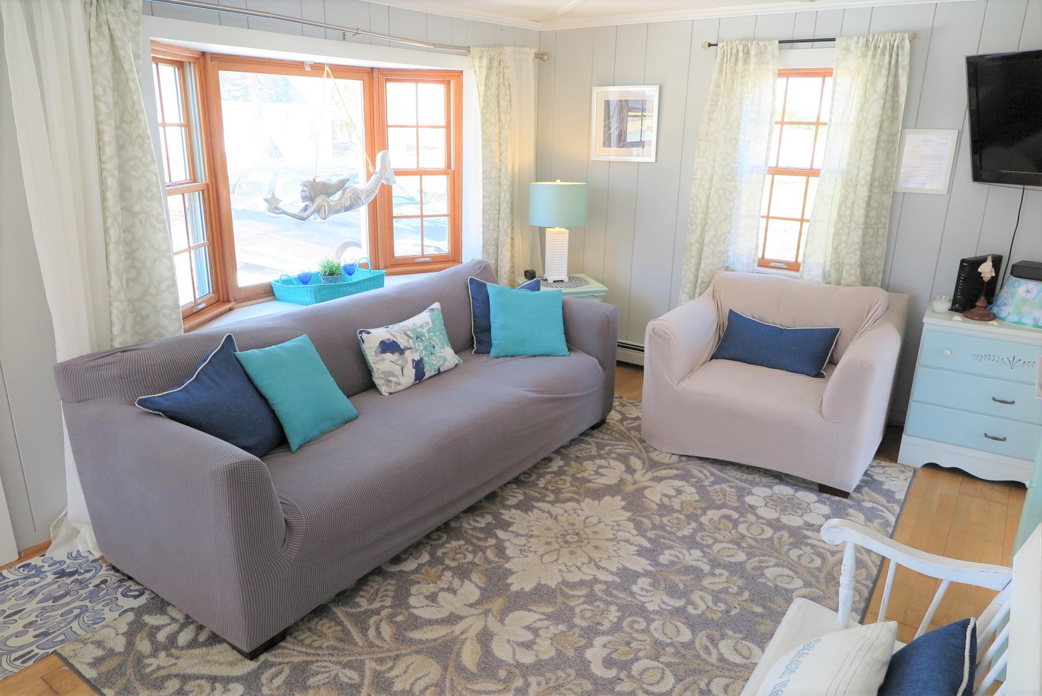 42 Bain Road Dennis Port, MA 02639 - Photo 6 of 46 a living room with furniture and a flat screen tv