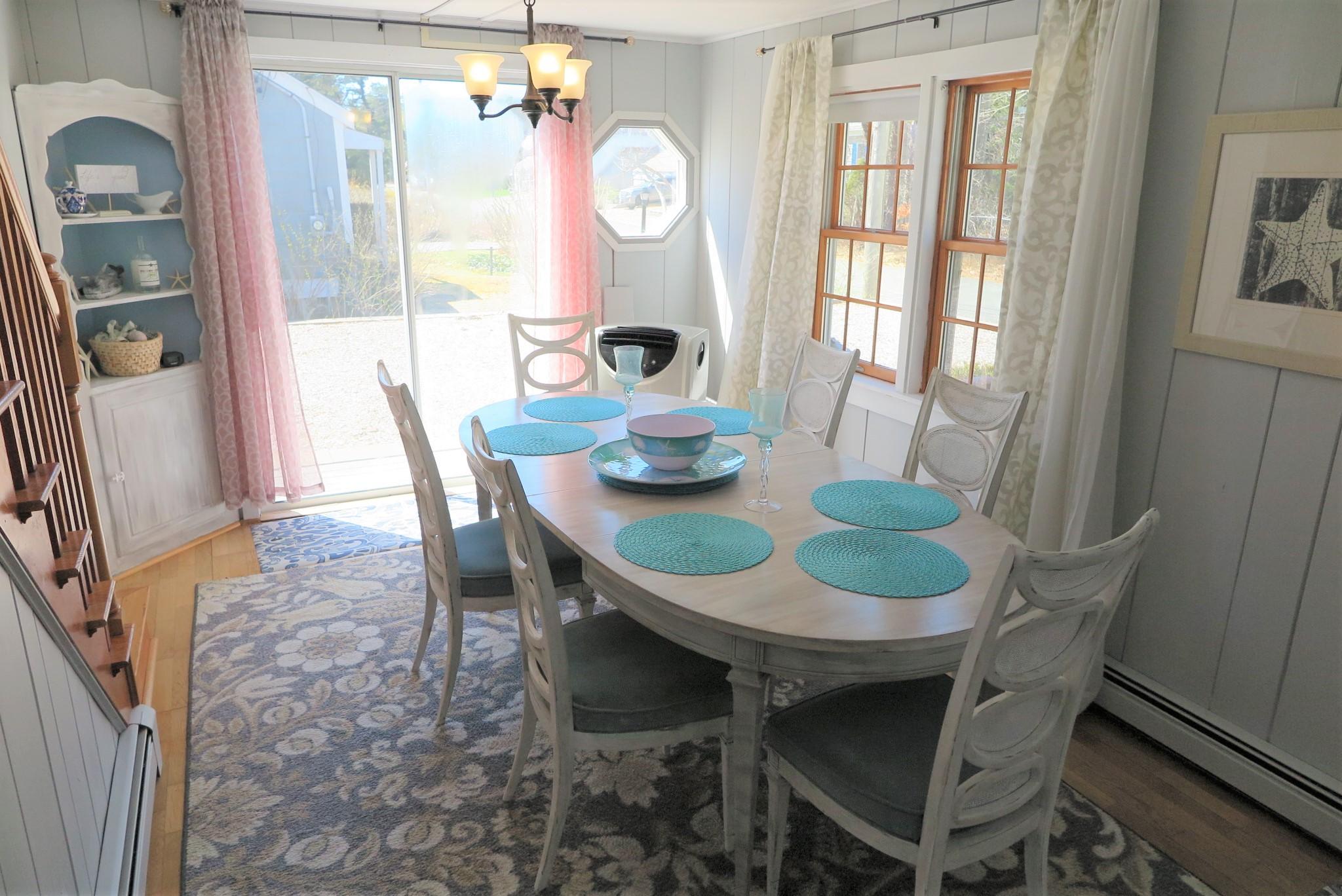 42 Bain Road Dennis Port, MA 02639 - Photo 9 of 46 a view of a dining room with furniture window and wooden floor