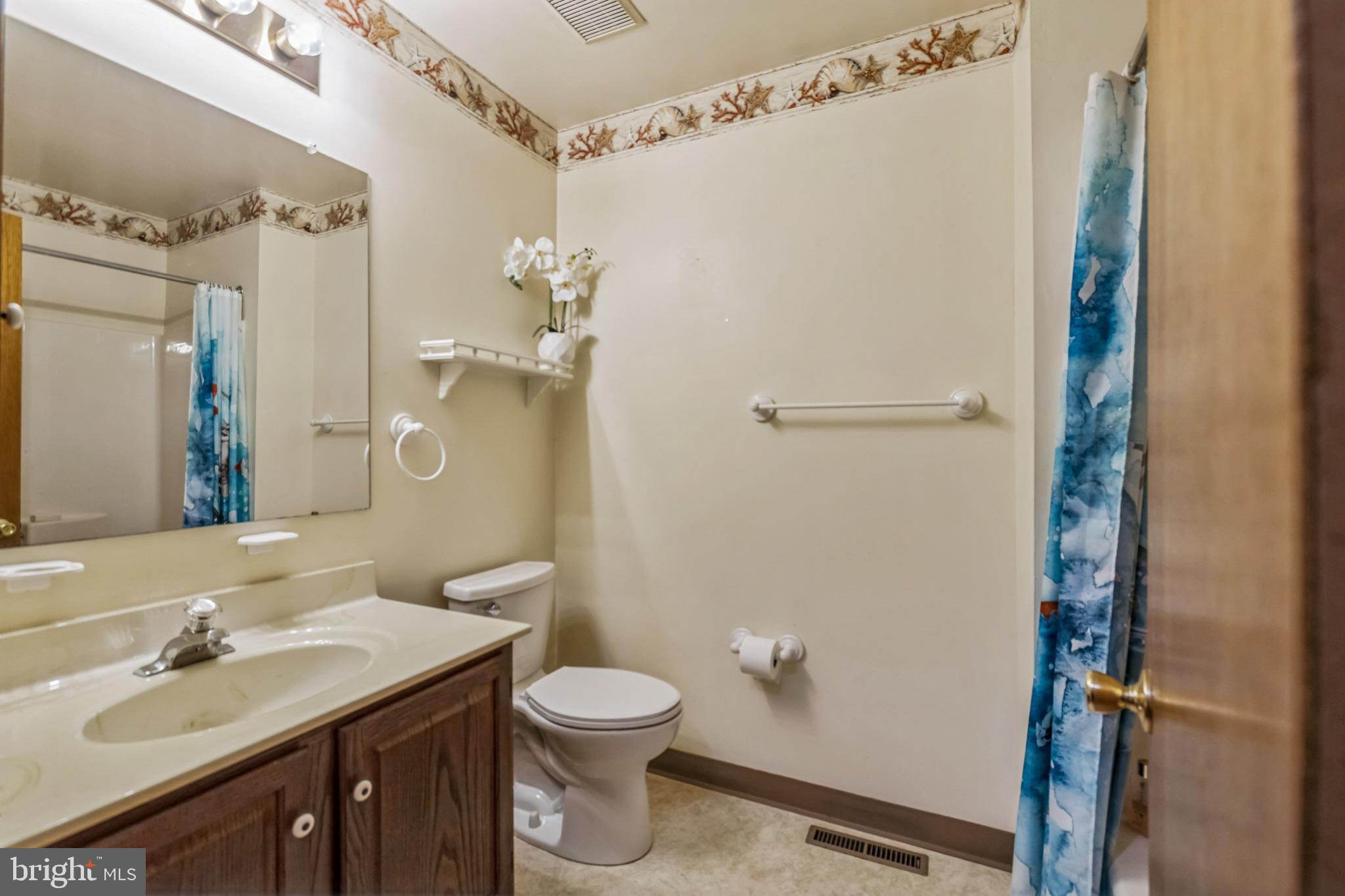 103 Upper Valley Lane Newark, DE 19711 - Photo 19 of 31 a bathroom with a sink a toilet and shower