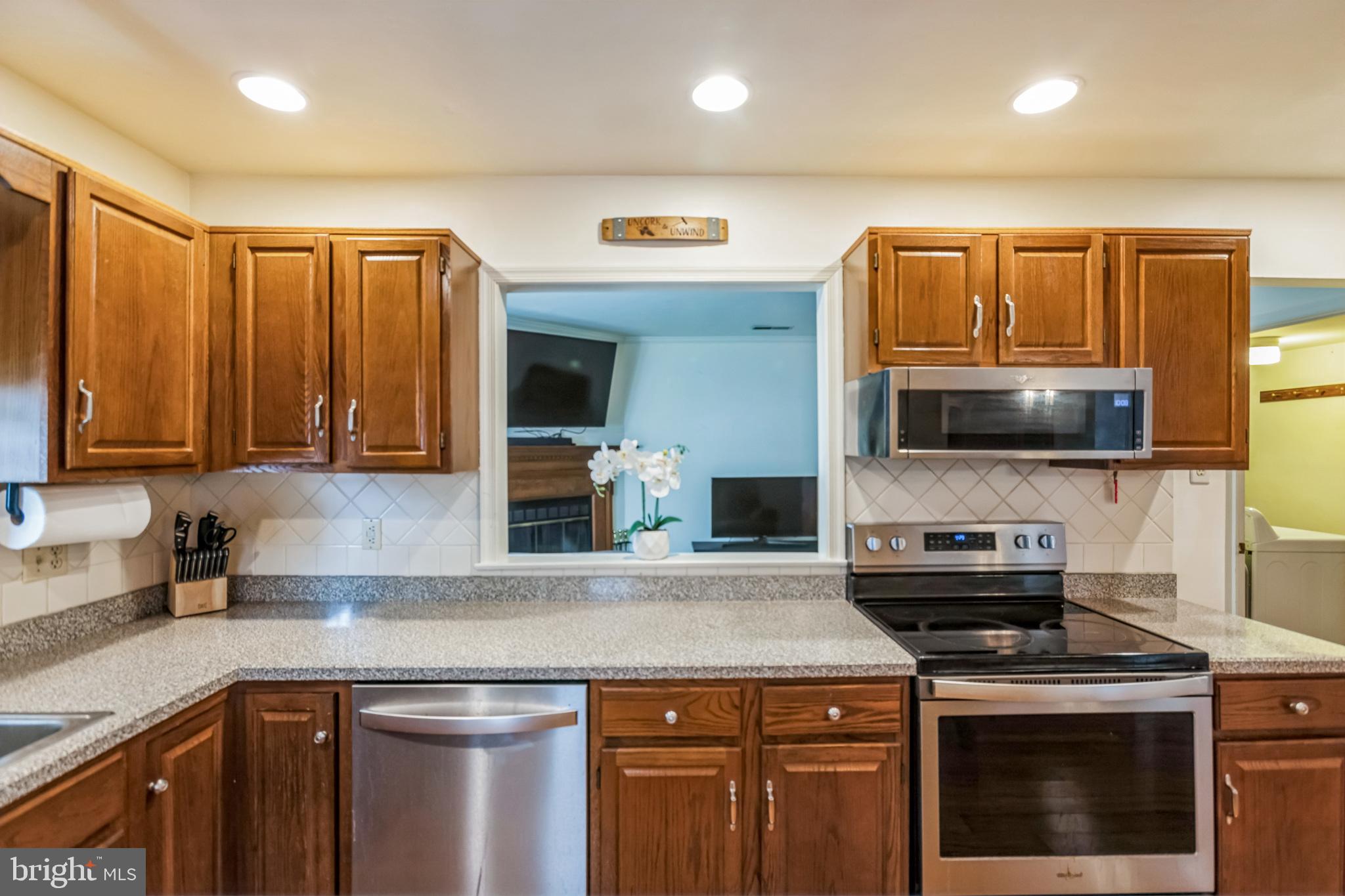 103 Upper Valley Lane Newark, DE 19711 - Photo 4 of 31 a kitchen with stainless steel appliances a stove microwave and sink