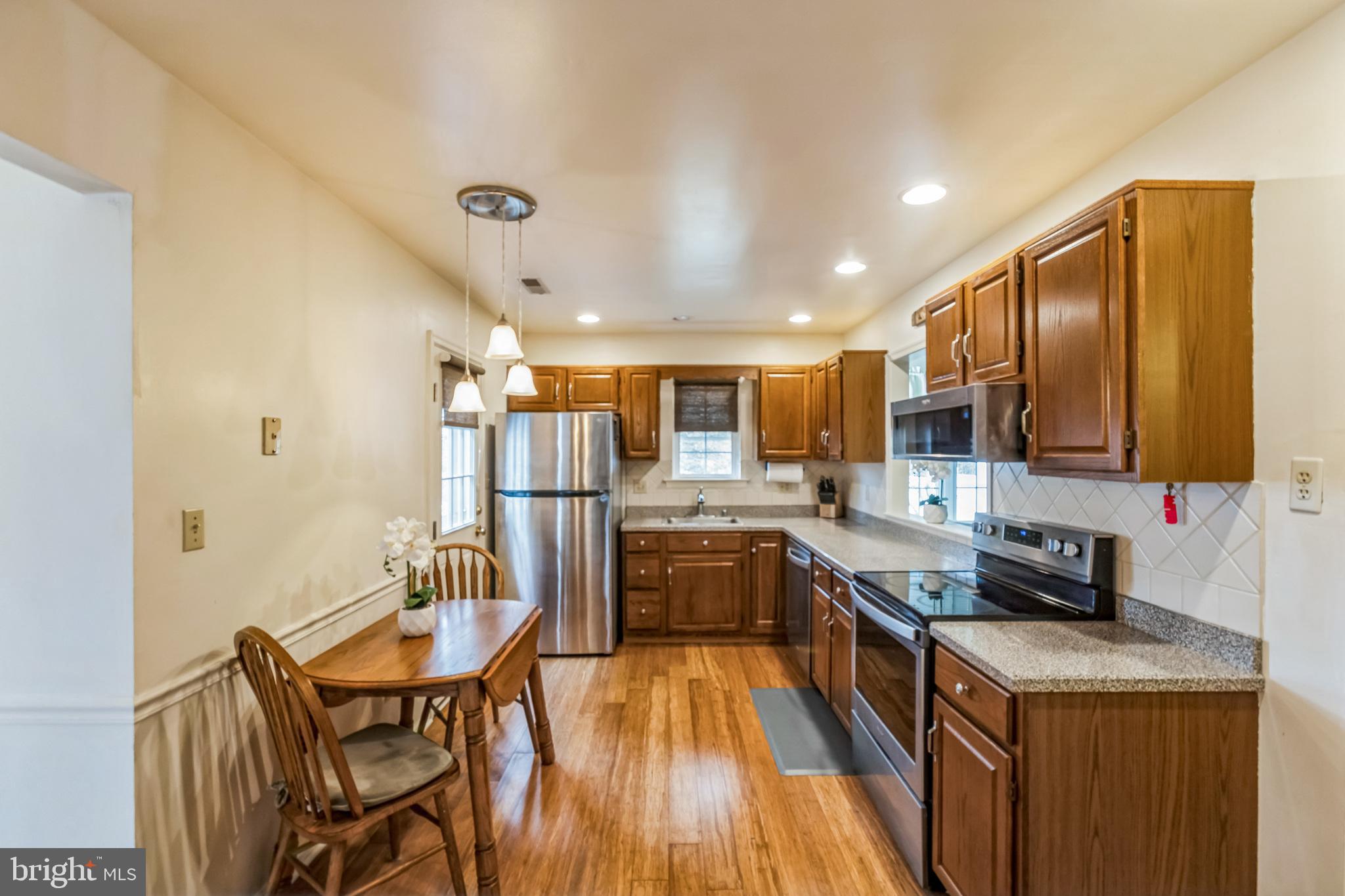 103 Upper Valley Lane Newark, DE 19711 - Photo 5 of 31 a kitchen with stainless steel appliances granite countertop sink stove top oven and cabinets