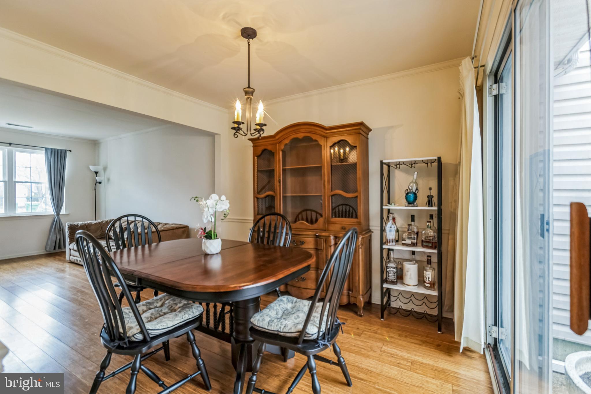 103 Upper Valley Lane Newark, DE 19711 - Photo 7 of 31 a dining room with furniture a chandelier and wooden floor