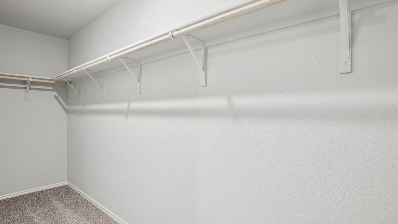 148 Wyatt Way Jarrell, TX 76537 - Photo 21 of 33 Carpeted walk-in closet featuring white wire shelving, hanging rods, and light-toned wall paint