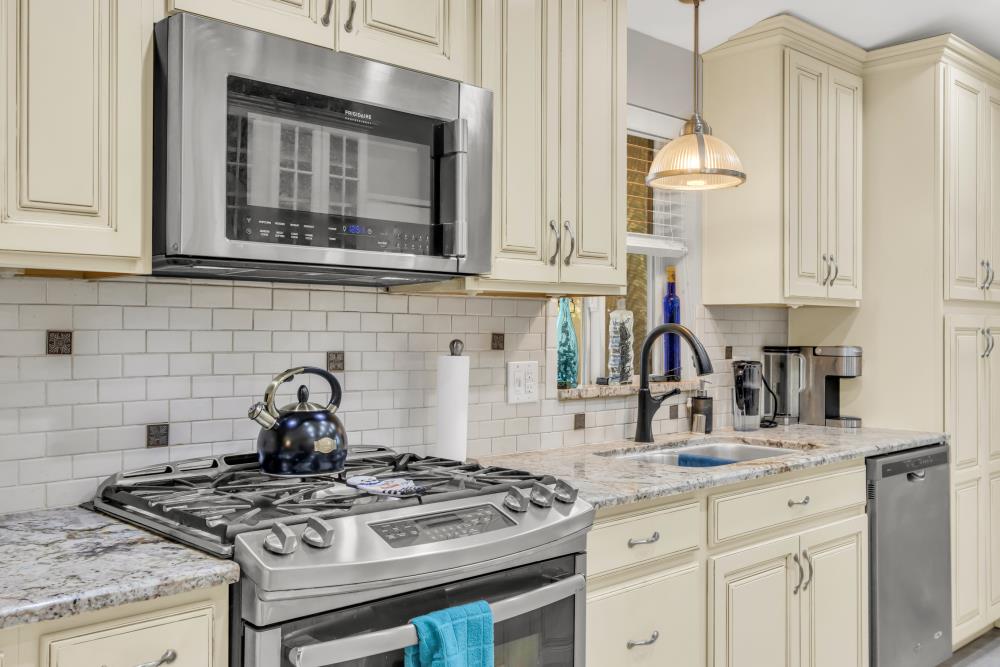 2000 Camanche Road, Unit 31 Ione, CA 95640 - Photo 19 of 43 a kitchen with granite countertop a stove a sink and a white cabinets