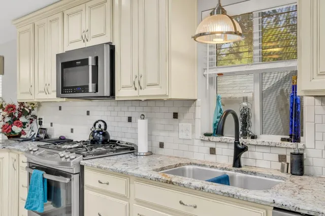 a kitchen with a sink stove and cabinets