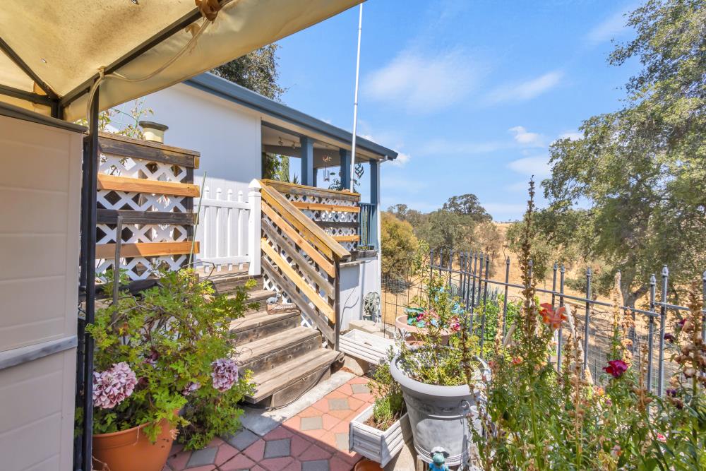2000 Camanche Road, Unit 31 Ione, CA 95640 - Photo 3 of 43 a view of a chair and table in the patio