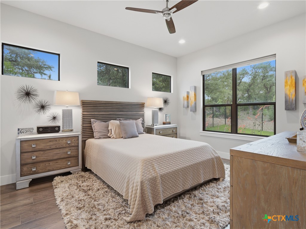5913 Verden Ridge New Braunfels, TX 78132 - Photo 20 of 48 a bedroom with a large bed and a window