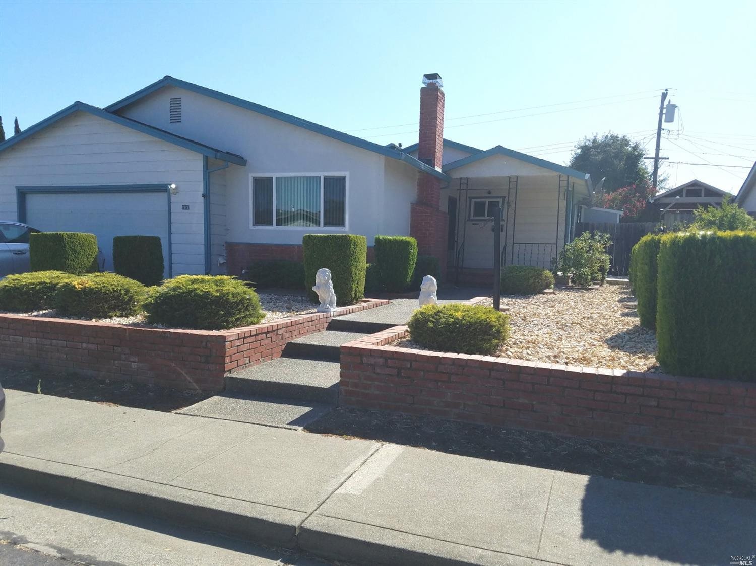 a front view of a house with garden
