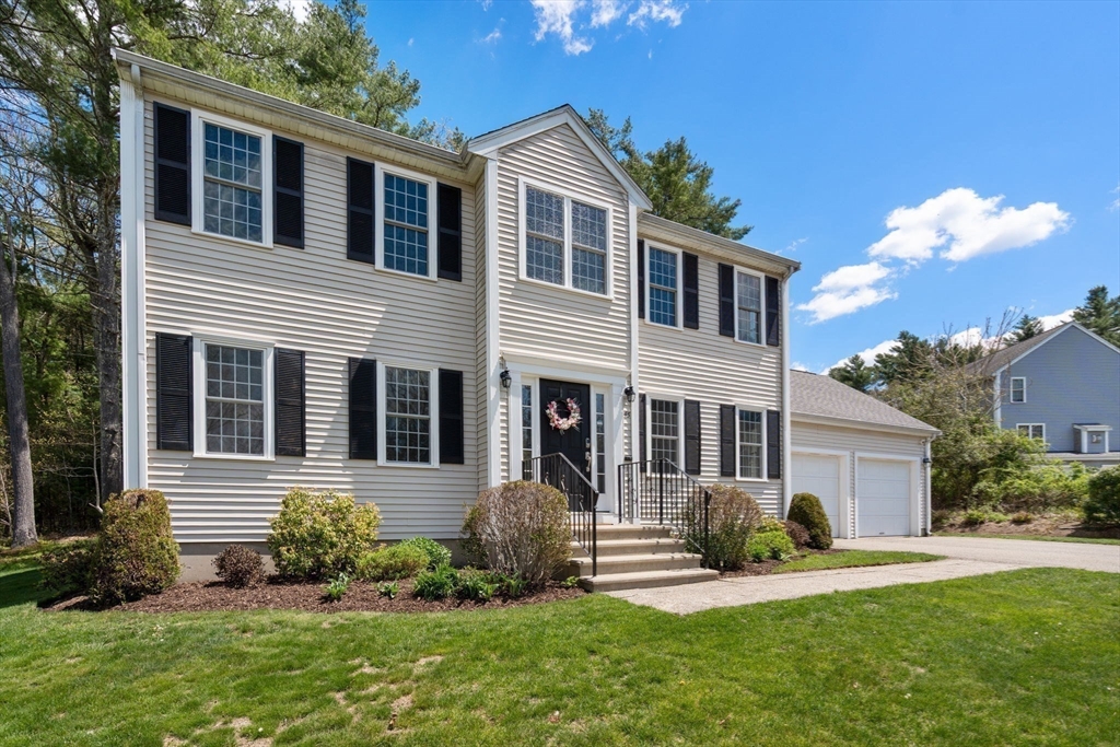 45 Cinnamon Ridge Circle Middleboro, MA 02346 - Photo 1 of 38 a front view of a house with a yard and potted plants