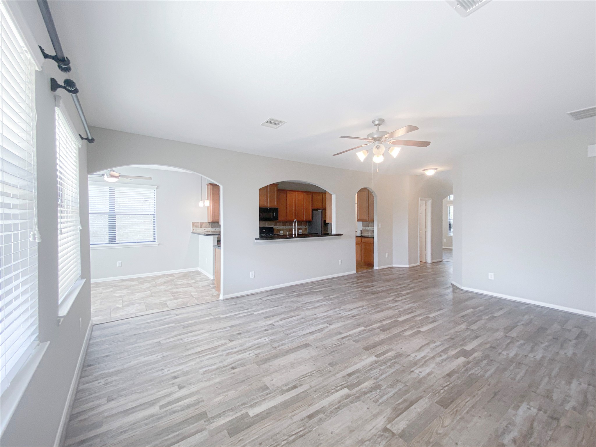 6227 Carnaby Lane Rosenberg, TX 77471 - Photo 12 of 30 Family with ceiling fans and large windows overlooking backyard