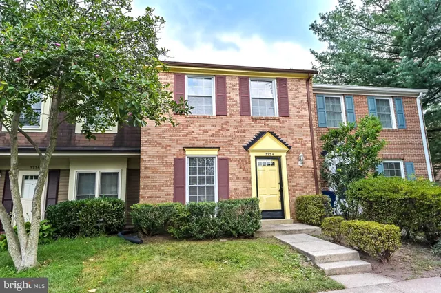 front view of brick house with a yard