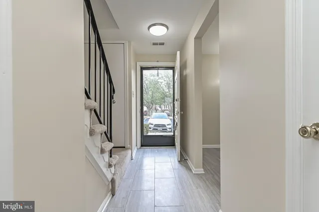 a view of an entryway with wooden floor