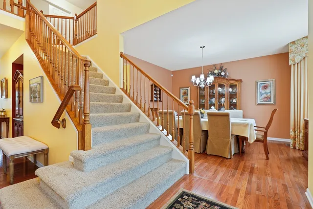 a view of entryway dining room and hall with wooden floor