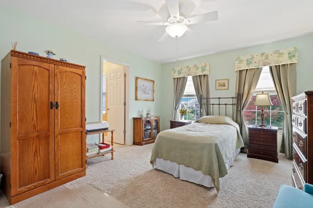 a bedroom with a bed closet and a window