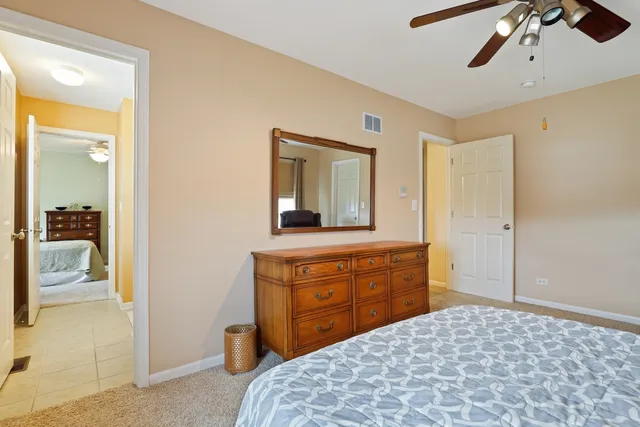 a bedroom with a bed and a dresser