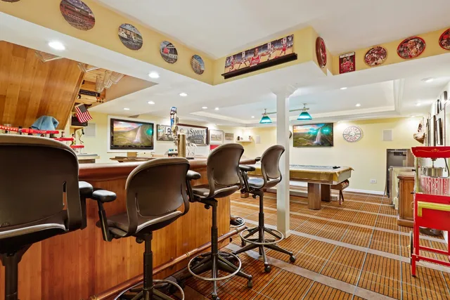 a living room with furniture a flat screen tv and kitchen view