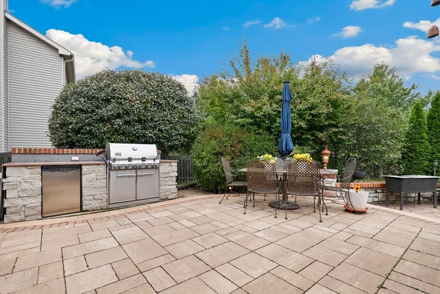 a view of a patio with table and chairs and potted plants