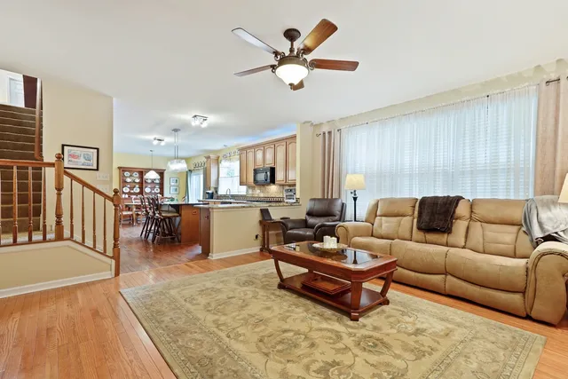 a living room with furniture and kitchen view