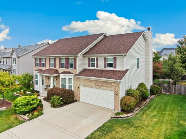 a aerial view of a house with a yard and plants