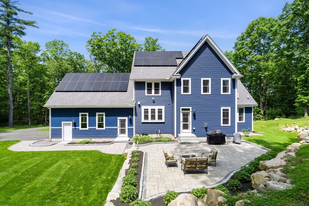 158 Warren Road Townsend, MA 01469 - Photo 2 of 41 a front view of a house with a yard table and chairs