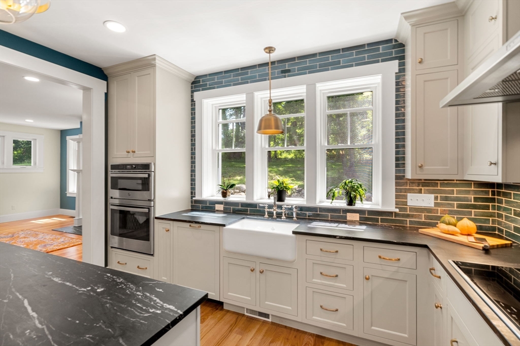 158 Warren Road Townsend, MA 01469 - Photo 5 of 41 a kitchen with stainless steel appliances granite countertop a stove and a sink