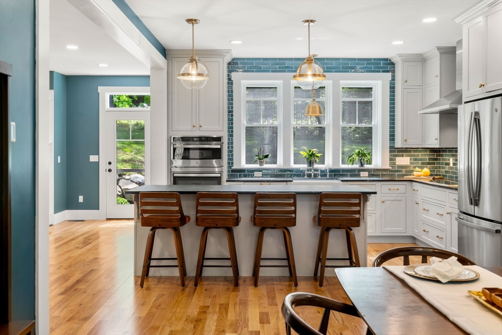 158 Warren Road Townsend, MA 01469 - Photo 7 of 41 a dining room with furniture a chandelier and wooden floor