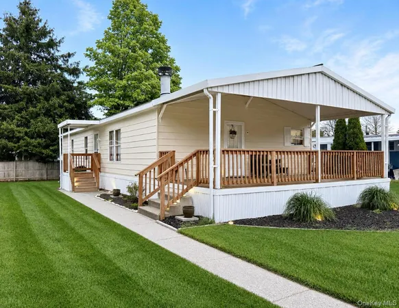 a view of a house with a yard and deck