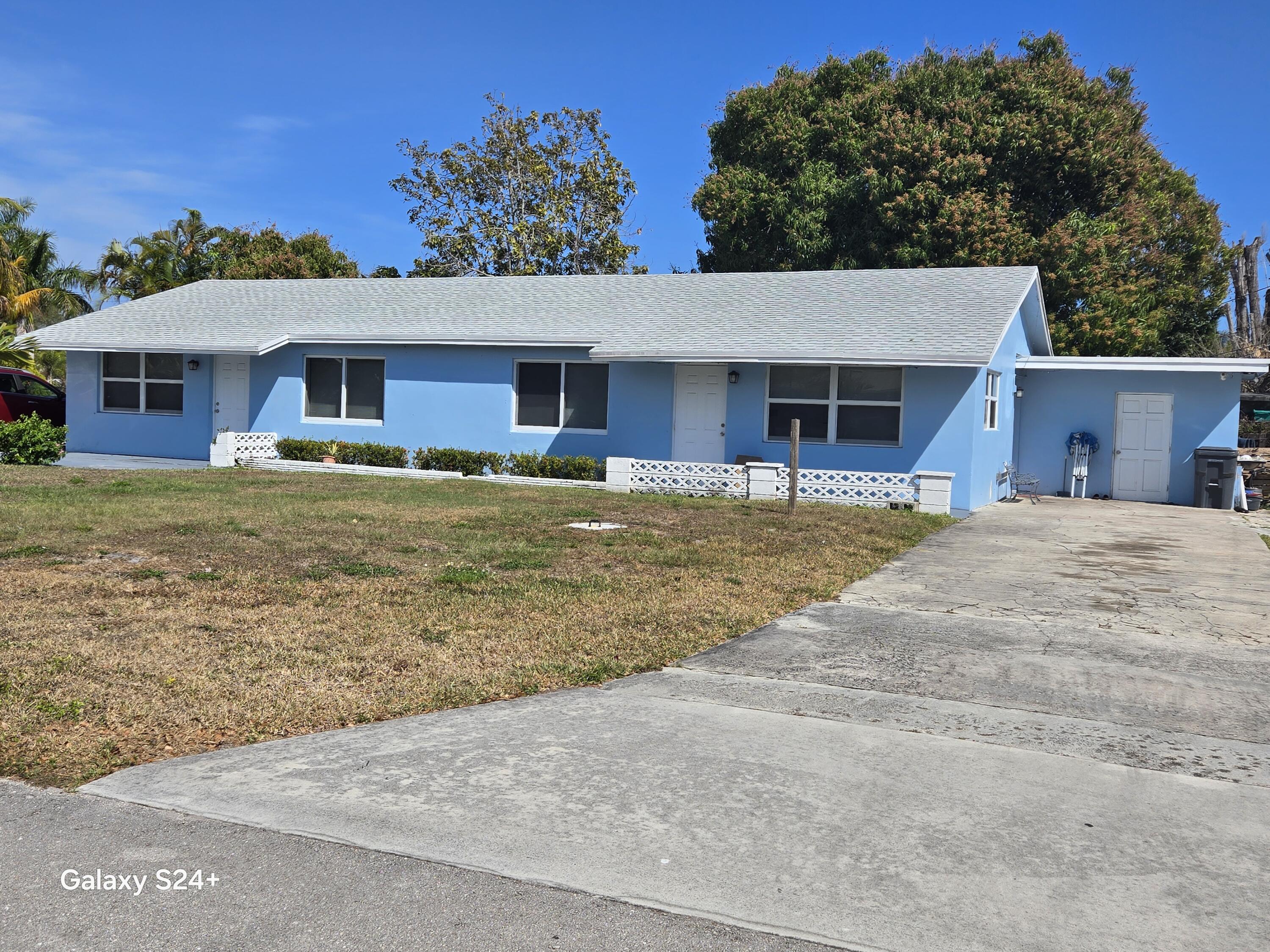 4258 Coconut Road Lake Worth, FL 33461 - Photo 2 of 14 a house view with a garden space