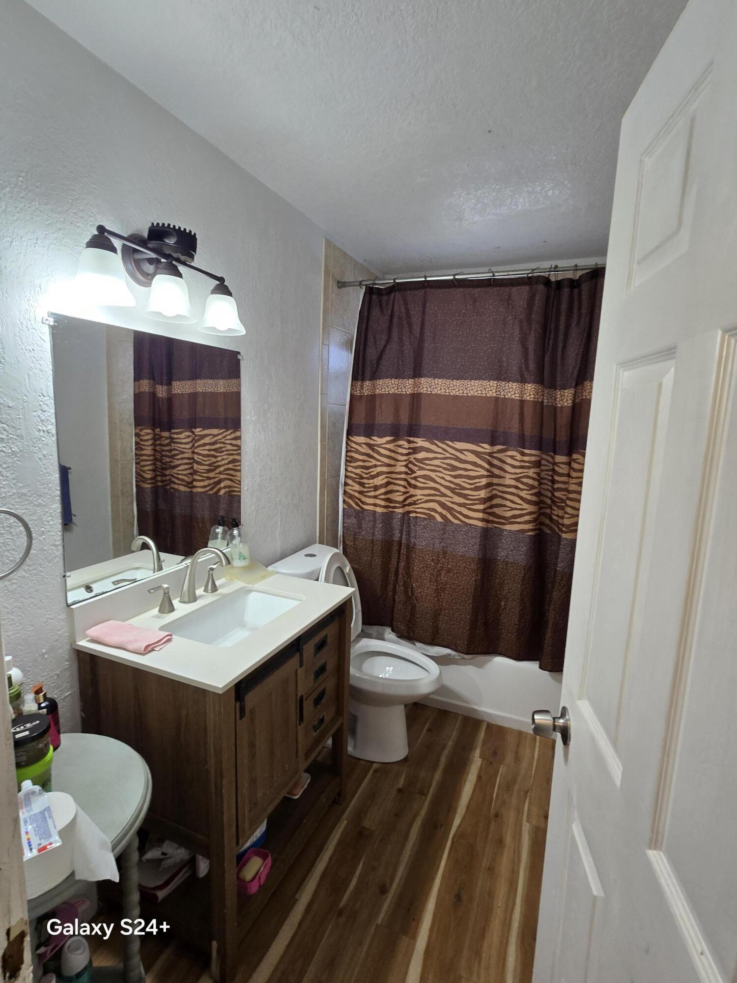 4258 Coconut Road Lake Worth, FL 33461 - Photo 4 of 14 a bathroom with a sink toilet and shower