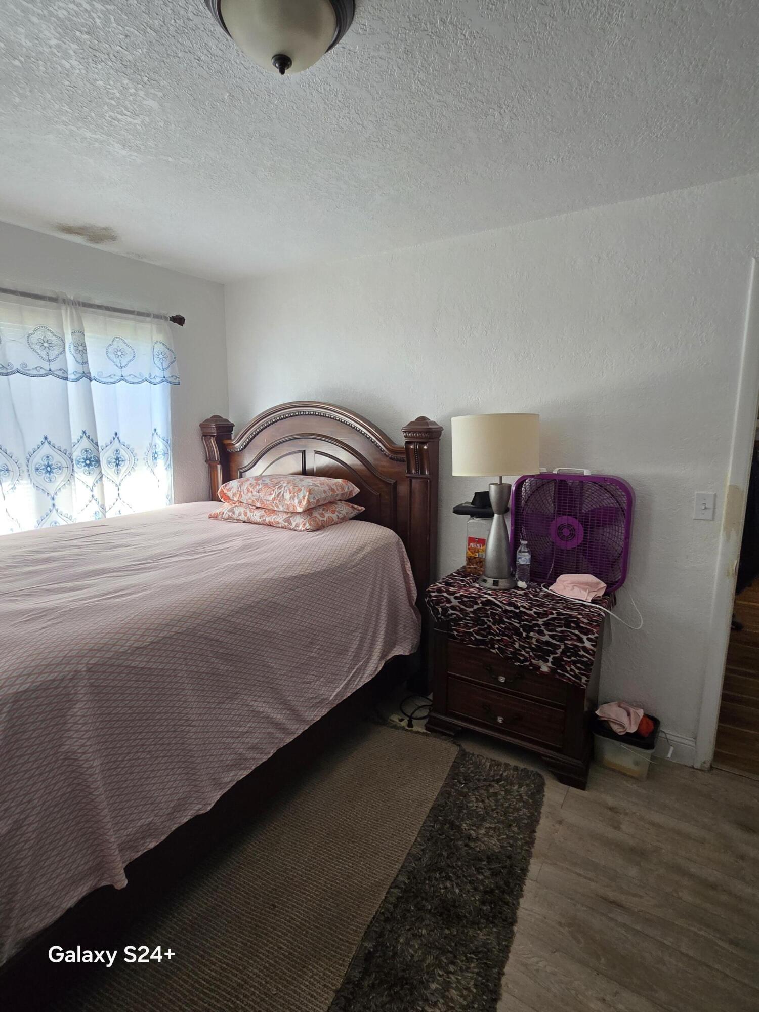 4258 Coconut Road Lake Worth, FL 33461 - Photo 8 of 14 a bedroom with bed and window