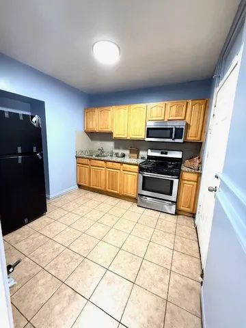 a kitchen with stainless steel appliances a stove a sink and a refrigerator