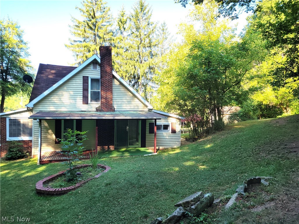 50658 Marietta Road Cumberland, OH 43732 - Photo 4 of 14 Rear view of house with a lawn