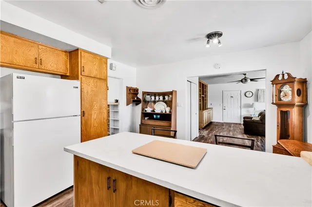 a bedroom with a bed and a refrigerator