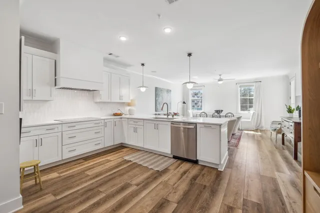 a kitchen with white cabinets and white appliances