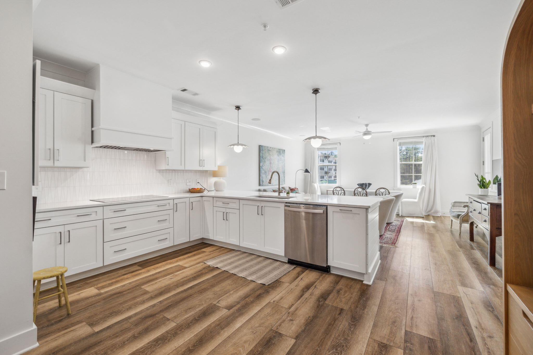 a kitchen with white cabinets and white appliances
